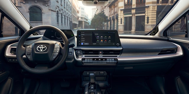 The Prius features a large touchscreen infotainment display.