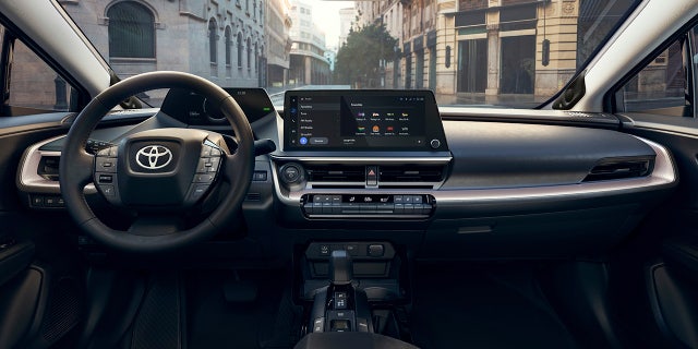 The Prius features a large touchscreen infotainment display.