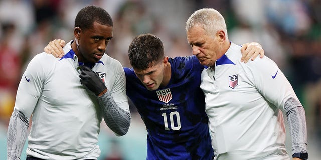 Christian Pulisic of the United States receives medical treatment after scoring the side's first goal during the FIFA World Cup Qatar 2022 Group B match against Iran at Al Thumama Stadium on November 29, 2022, in Doha, Qatar.