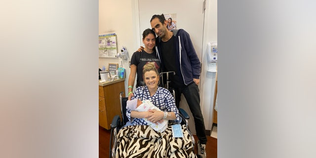 At the hospital, Neema and Victoria Raphael celebrate the birth of their son, Ezra, through their surrogate, Kristina Bontrager.