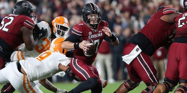 South Carolina quarterback Spencer Rattler (7) crawls past Tennessee defenseman Tyler Baron (9) during the first half of an NCAA college football game Saturday, November 19, 2022 in Columbia, SC