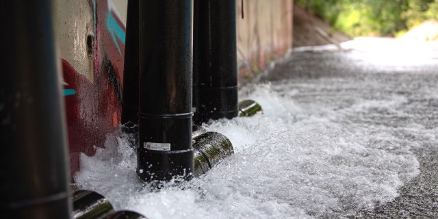 Up to 3,500 gallons of water per minute from the Red Hill Well is discharged into Halawa Stream on Jan. 31, 2022, as the Navy flushes the water supply. Hundreds of families say they were sickened after drinking fuel-contaminated water.