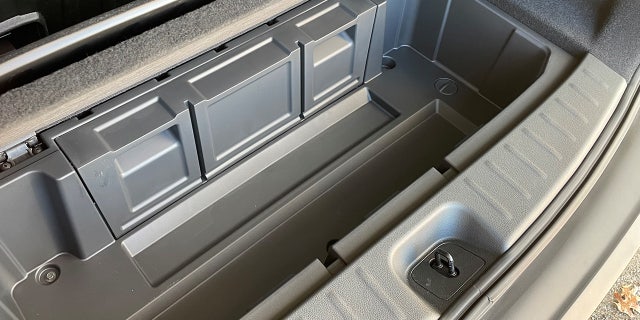 A wheelbarrow-style storage compartment is found beneath the cargo area floor.