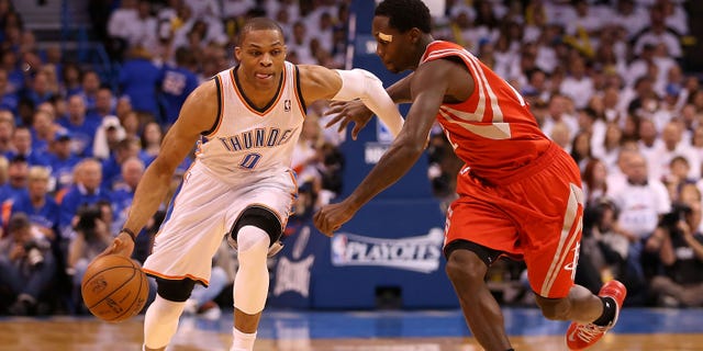 Russell Westbrook drives past Patrick Beverley during the NBA Playoffs on April 24, 2013, in Oklahoma City, Oklahoma.