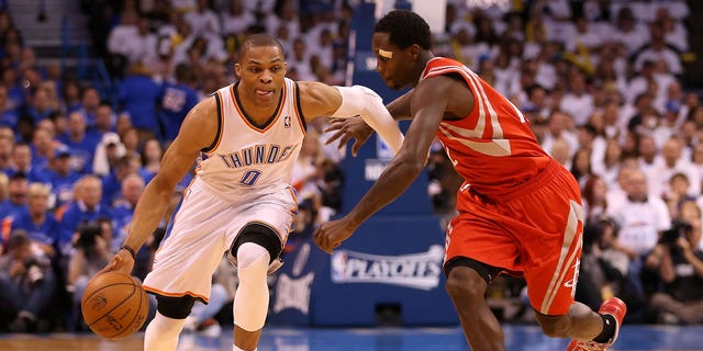 Russell Westbrook drives past Patrick Beverley during the NBA Playoffs on April 24, 2013, in Oklahoma City, Oklahoma.