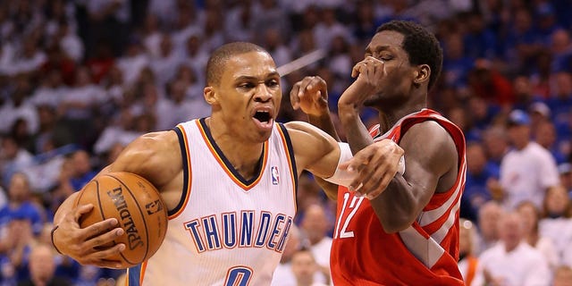 Russell Westbrook of the Thunder handles the ball under pressure from Patrick Beverley of the Houston Rockets during the NBA Playoffs on April 24, 2013, in Oklahoma City. The Thunder won, 105-102.