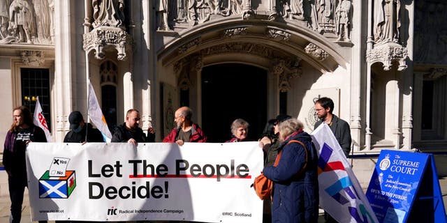 Supporters of Scottish independence hold a banner outside the Supreme Court in London on Tuesday October 11, 2022.  The UK Supreme Court is due on Wednesday 23 November 2022 to rule on whether Scotland can vote on independence without the consent of the UK government, a case with huge implications for the future of the UK.