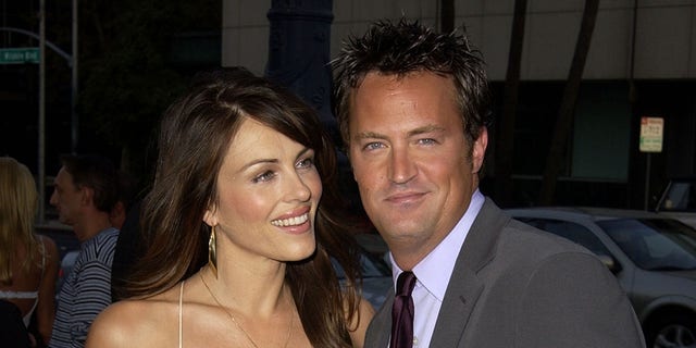 Elizabeth Hurley and Matthew Perry attend the 2002 premiere of 