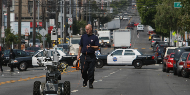 The San Francisco Police, bomb investigating robot, returns from down 16th street after looking over the device. The San Francsico Police bomb squard closed of 16th street between Folson and Harrison Streets, in San Francsico, Calif.