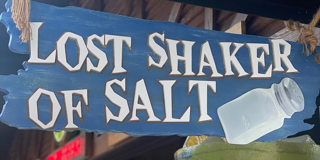 See in this image is a "Lost Shaker of Salt" sign at the bar in Margaritaville.