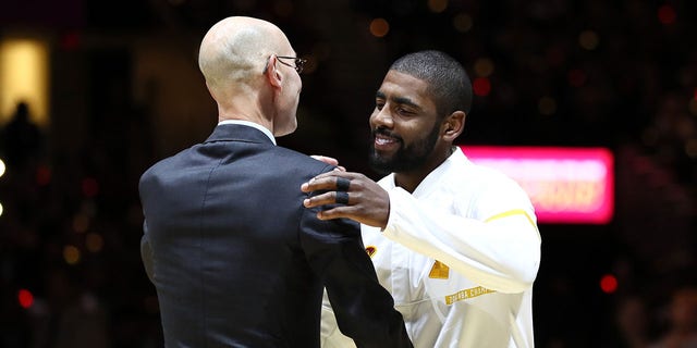 Kyrie Irving, right, shakes hands with NBA Commissioner Adam Silver on Oct. 25, 2016, in Cleveland.