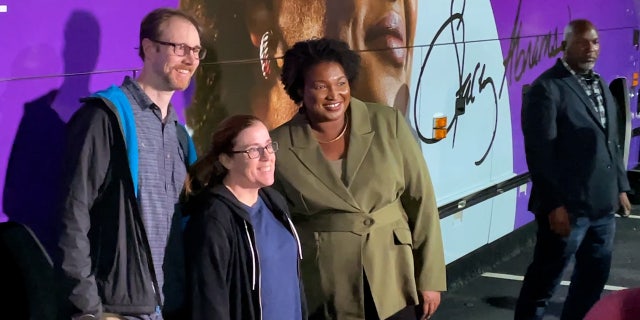 Democrat Stacey Abrams poses for photos with supporters during a No. 1, 2022, campaign stop in Marietta, Georgia.