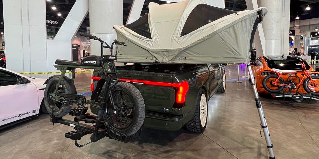 The truck has been equipped with a tent and electric off-road bike.