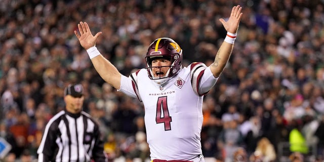 Taylor Heinicke #4 of the Washington Commanders celebrates a touchdown scored by Brian Robinson Jr. #8 against the Philadelphia Eagles during the second quarter in the game at Lincoln Financial Field on November 14, 2022 in Philadelphia, Pennsylvania.