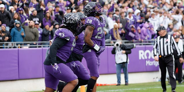 TCU Horned Frogs safety Millard Bradford (28) celebrates with his teammates after returning an interception for a touchdown during the game between the TCU Horned Frogs and the Iowa State Cyclones on November 26, 2022 at Amon G. Carter Stadium in Fort Worth, Texas.