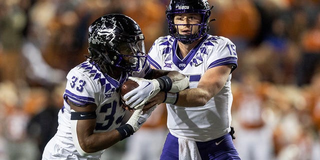 TCU quarterback Max Duggan (15) hands running back Kendre Miller (33) in charge during the first half of the team's NCAA college football game against Texas on Saturday, November 12, 2022 in Austin, Texas.