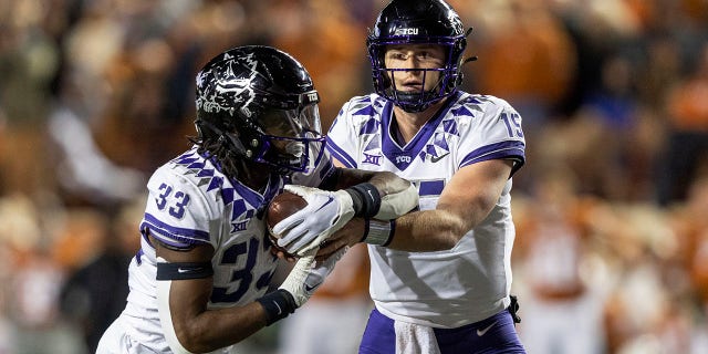 TCU quarterback Max Duggan (15) hands off to running back Kendre Miller (33) during the first half of the team's NCAA college football game against Texas on Saturday, Nov. 12, 2022, in Austin, Texas.