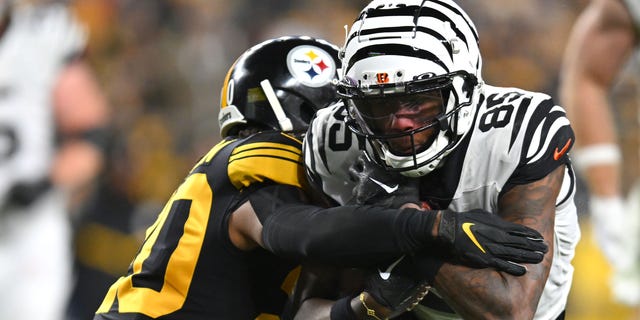 Cameron Sutton (20) of the Pittsburgh Steelers tackles Tee Higgins of the Cincinnati Bengals during the second quarter at Acrisure Stadium on Nov. 20, 2022, in Pittsburgh.
