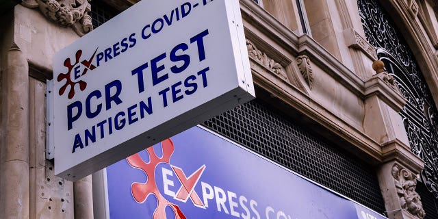 A sign for express Covid-19 PCR testing is pictured in London on July 11, 2022.