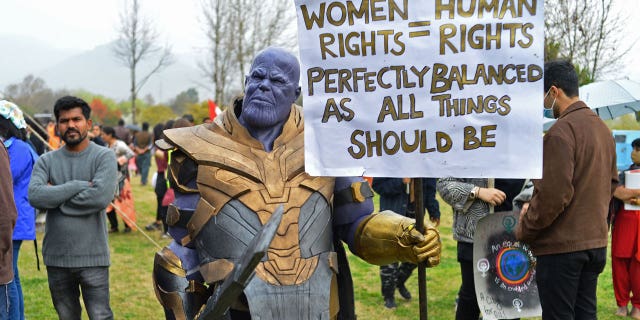 A man wearing a costume of Thanos' character takes part in a women independence march. Thanos is a villain from