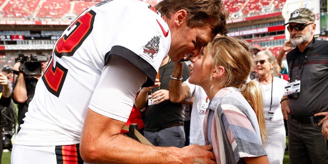 Tom Brady of the Buccaneers talks with his daughter Vivian on the sidelines before the Green Bay Packers game at Raymond James Stadium on Sept. 25, 2022, in Tampa, Florida.