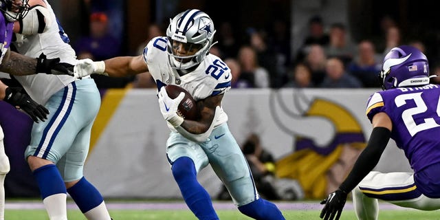 Tony Pollard of the Dallas Cowboys carries the ball against the Minnesota Vikings during the first half at U.S. Bank Stadium on Nov. 20, 2022, in Minneapolis.