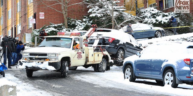 A Ford Explorer relevant to the investigation of four murdered college students in Moscow, Idaho is towed by police investigators