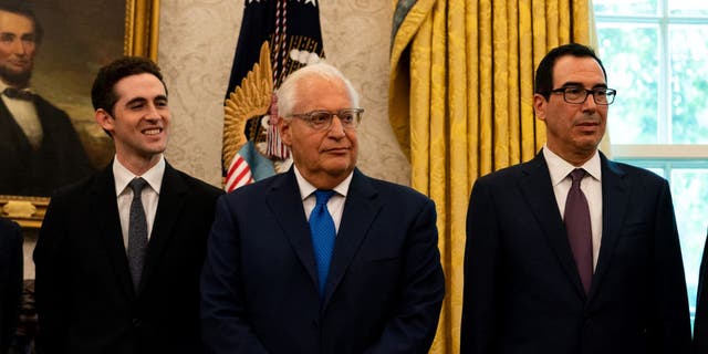 David Friedman, U.S. ambassador to Israel, center, and Steven Mnuchin, U.S. Treasury secretary, right, listen during a press conference on Israel and Bahrain