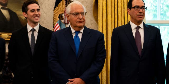 David Friedman, U.S. ambassador to Israel, center, and Steven Mnuchin, U.S. Treasury secretary, right, listen during a press conference on Israel and Bahrain