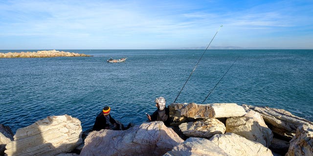 Coastal livelihoods are under threat again after the Mediterranean suffered from another marine heatwave deadly to many aquatic species. Pictured: Men fishing at the end of a jetty at port La Goulette in Tunis, Tunisia, on Jan. 3, 2018.