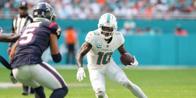 Tyreek Hill #10 of the Miami Dolphins runs the ball during the first quarter in the game against the Houston Texans at Hard Rock Stadium on November 27, 2022 in Miami Gardens, Florida.