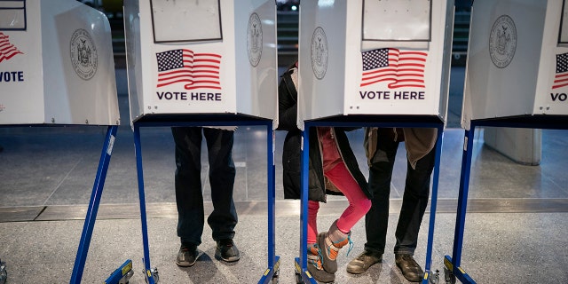 Voters fill out their ballots before bringing them to counting machines at a polling site in the Brooklyn Museum as the doors open for the midterm election, Tuesday, Nov. 8, 2022, in the Brooklyn borough of New York.