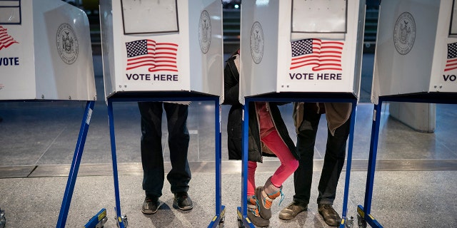 Voters fill out their ballots before bringing them to counting machines at a polling site in the Brooklyn Museum as the doors open for the midterm election, Tuesday, Nov. 8, 2022, in the Brooklyn borough of New York. 