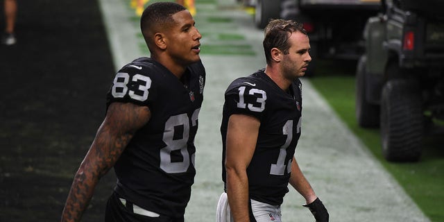 Darren Waller (83) and Hunter Renfrow (13) of the Las Vegas Raiders walk off the field after the team's 30-23 loss to the Buffalo Bills at Allegiant Stadium Oct. 4, 2020, in Las Vegas.  