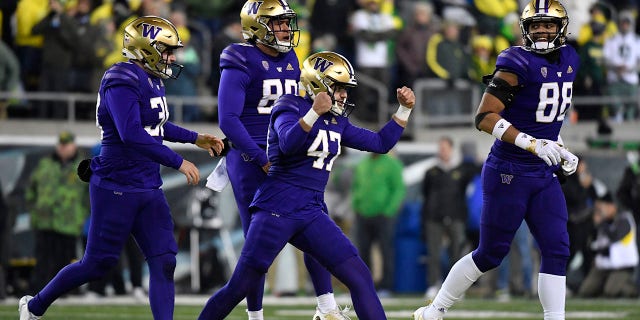 Washington placekicker Peyton Henry (47) celebrates ith punter Jack McCallister (38), tight end Quentin Moore (88) and long snapper Jaden Green (89) after making a field goal during the second half of an NCAA college football game against Oregon, Saturday, Nov. 12, 2022, in Eugene, Ore.Â