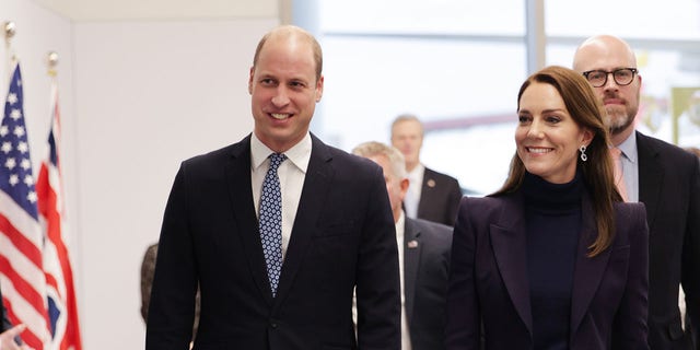 Prince William and Kate Middleton walk through Boston's Logan International Airport on Wednesday. 