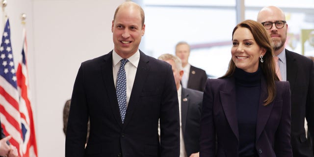Prince William and Kate Middleton walk through Boston's Logan International Airport on Wednesday.