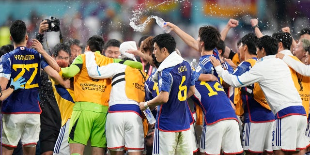 Japan players celebrate after the World Cup Group E soccer match between Germany and Japan at Khalifa International Stadium in Doha, Qatar, Wednesday, Nov. 23, 2022.