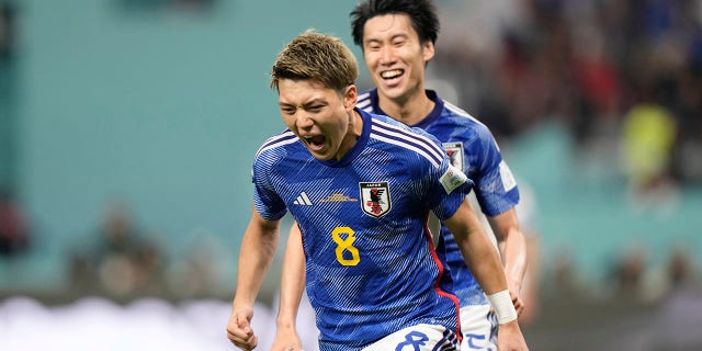 Japan's Ritsu Doan celebrates after scoring his side's opening goal during the World Cup Group E soccer match between Germany and Japan at Khalifa International Stadium in Doha, Qatar, Wednesday, Nov. 23, 2022.