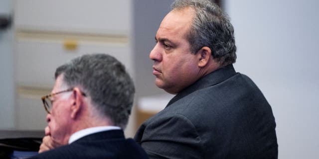 Defendant Bahram Hojreh, right, listens to opening statements with his attorney, John Barnett, during his trial in Orange County Superior Court in Santa Ana, CA