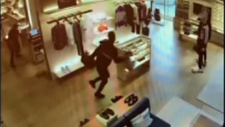 Man knocks himself out trying to flee store with luxury stolen goods, video shows Man knocks himself out trying to flee store with luxury stolen goods, video shows