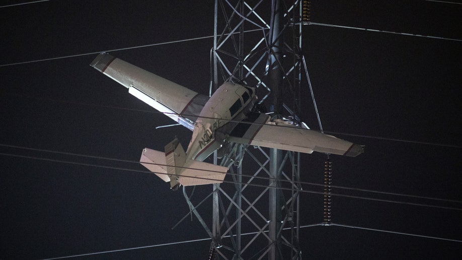 A close of up of the plane lodged in the power lines