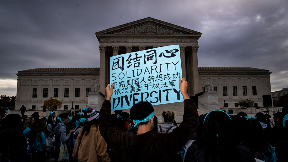 Rally-goer holds a sign in support of affirmative action