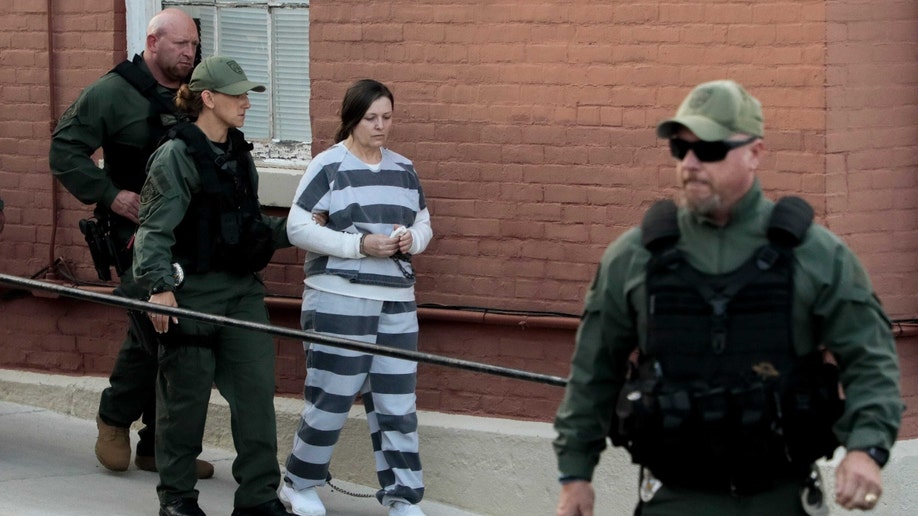 Angela Wagner escorted by prison guards