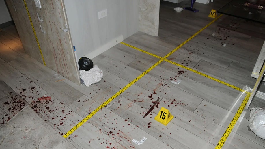 An evidence marker near blood splatter.