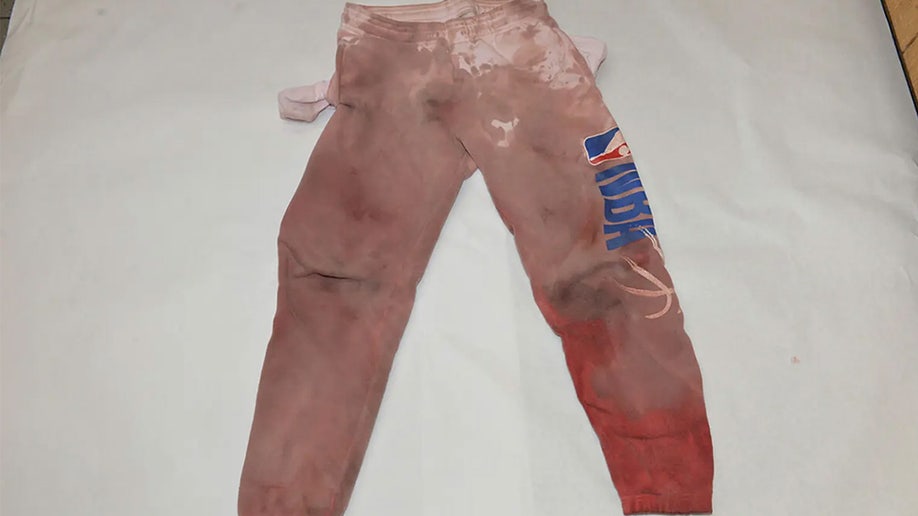 Clenney's sweats with the right leg soaked in blood.