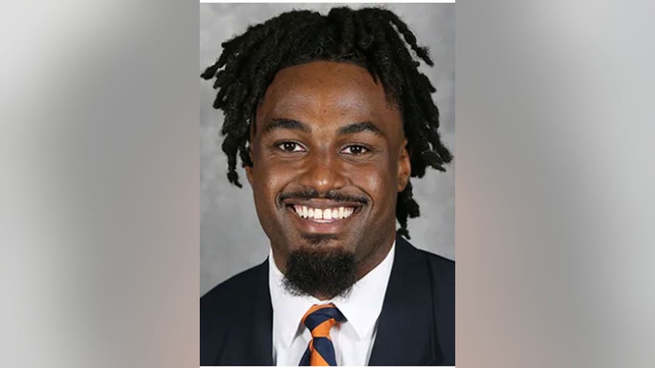 D'Sean Perry smiles in suit