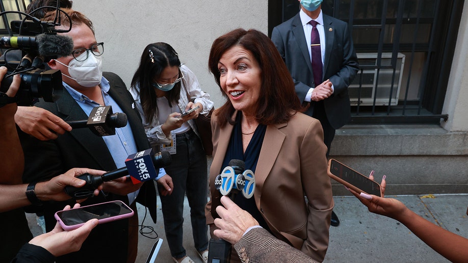 Hochul surrounded by reporters