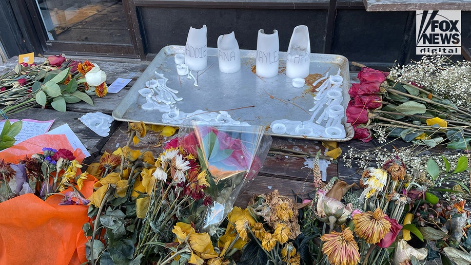 Makeshift memorial with candles and flowers