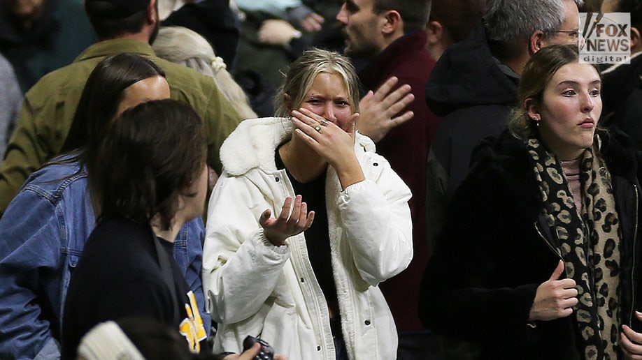A mourner crying at the University of Idaho vigil